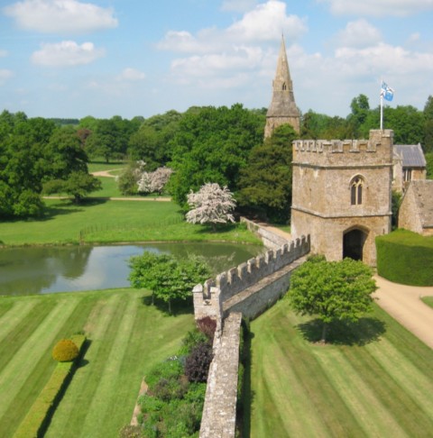 The church, the gate house and curtain wall and moat of Broughton Castle, Oxfordshire, dating from the 14th century. The Great Hall is in near original condition and the photo was taken from the roof.